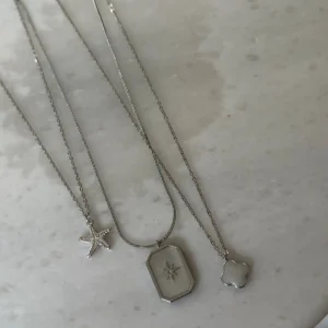 ست گردنبند سه‌گانه از جنس فولاد ضد زنگ 316L با روکش رودیوم، شامل طرح مدل شبدر و ستاره دریایی - 7642
